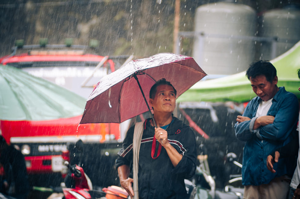 The sky opened, but the spirit stood firm. Rain interrupted the launches, but not the smiles or the hopes. This man, under his umbrella, kept looking up.