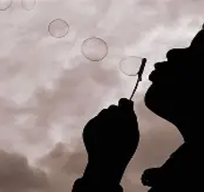 Child silhouette blowing bubbles