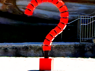 3 meter tall sculpture in the shape of a question mark in bright red