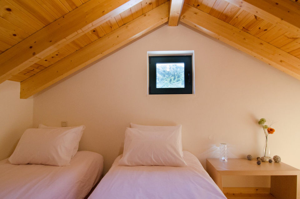 Two single beds in the attic, viewed from the front.