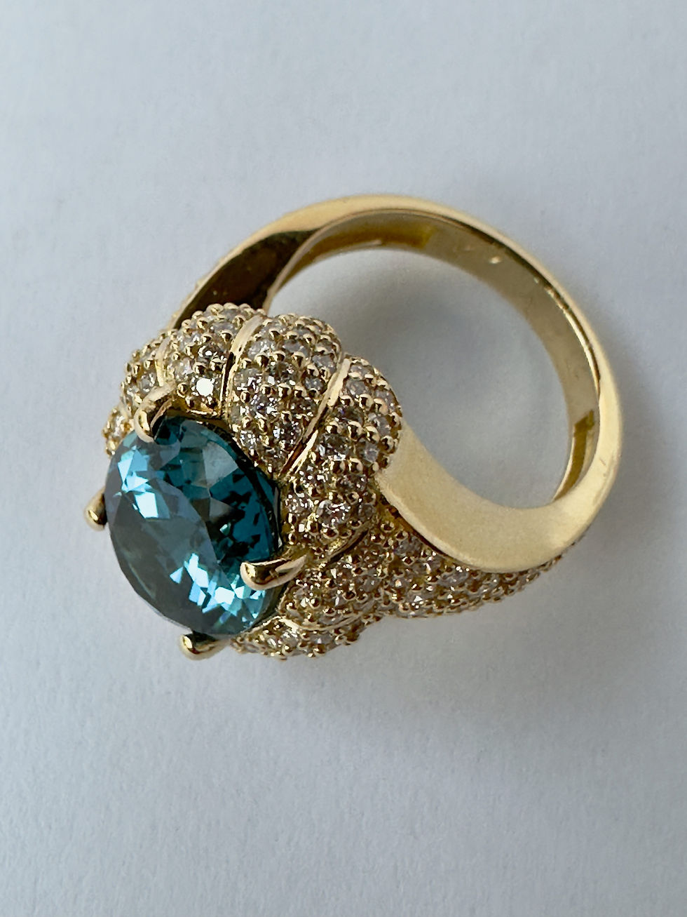 Thumbnail: 7 Carat Oval-Cut London Blue Topaz and Diamond Halo Ring in Yellow Gold