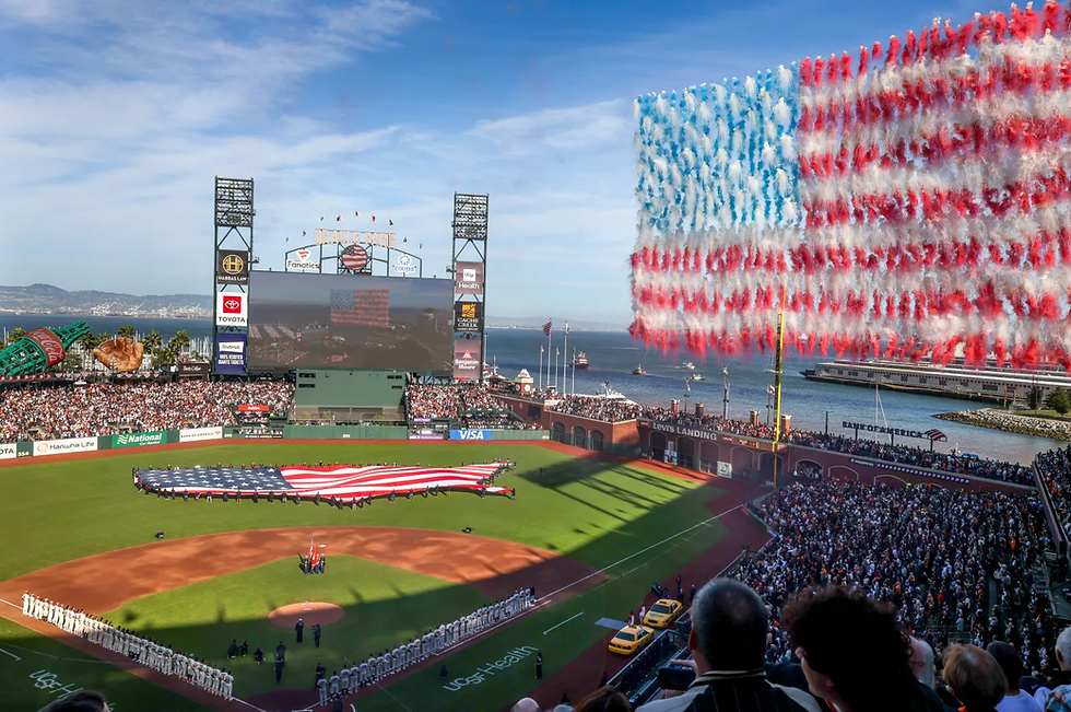Giants and Yankees stand on the field during the national anthem on Opening Night.