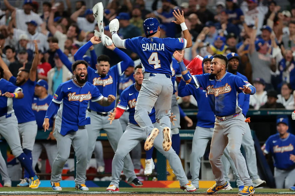 Javier Sanoja celebrating scoring a run in the ninth inning of the WBC Final.