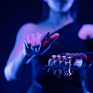 Human pointing forward with a robotic arm, illustrating Artificial Intelligence