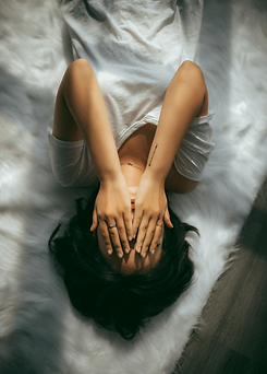Trauma Counselling, woman covering her face with her hands to hide.