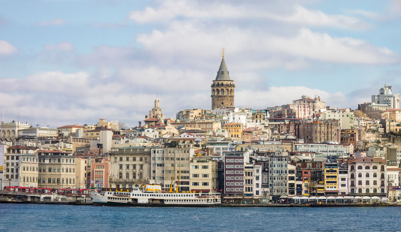 Istanbul cityscape with historic Galata Tower overlooking the Bosphorus strait.