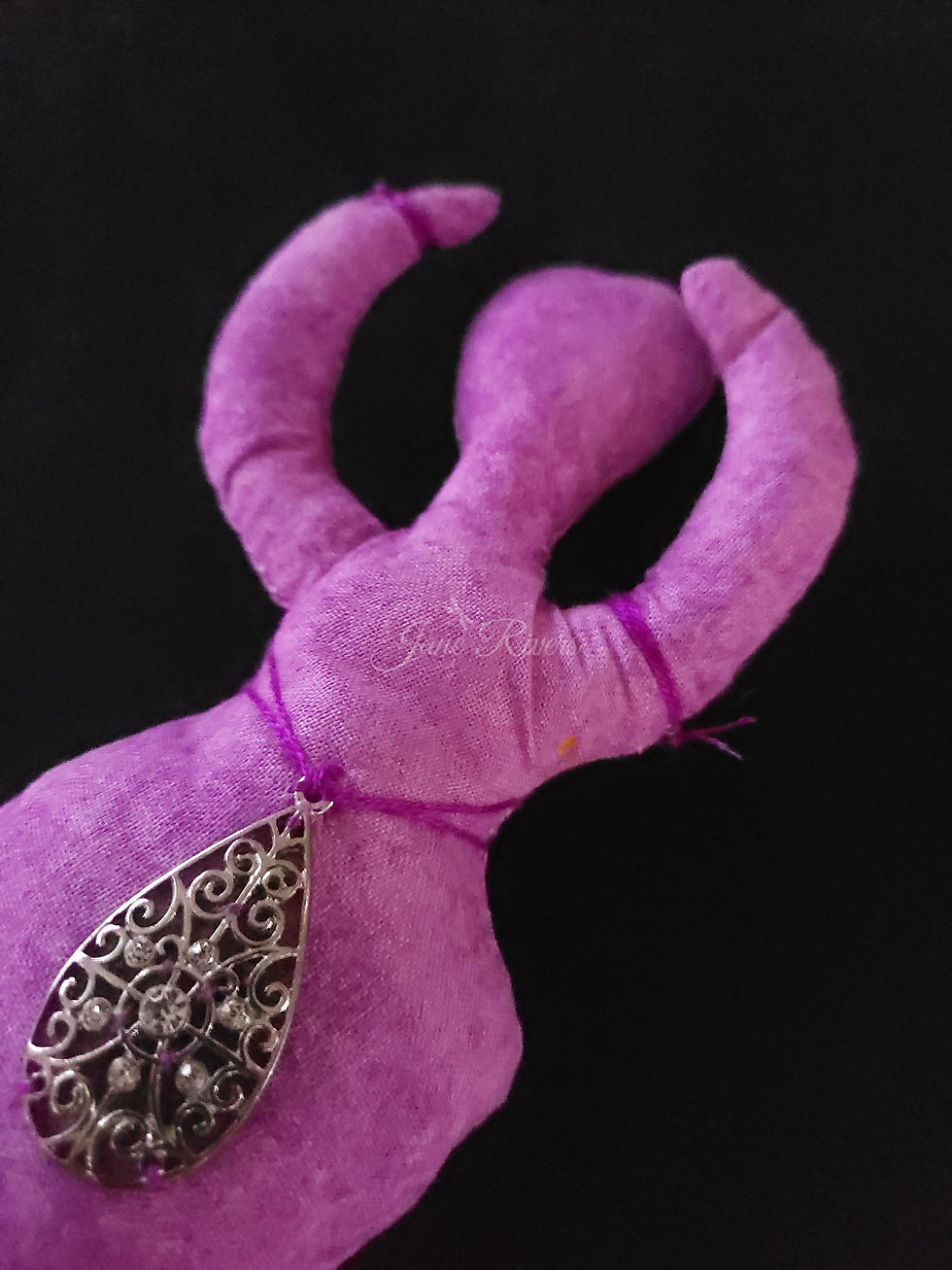 Thumbnail: close up of stitching on purple godess doll