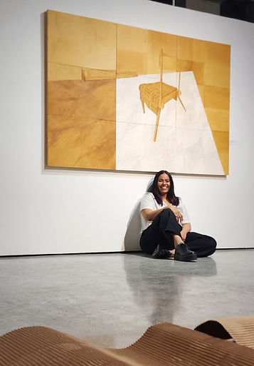 Photo of the Artist with her work.