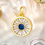 Thumbnail: Close-up of Shimmering Bay Charm with sapphire-colored center and radiant baguette-style accents in gold-filled setting.
