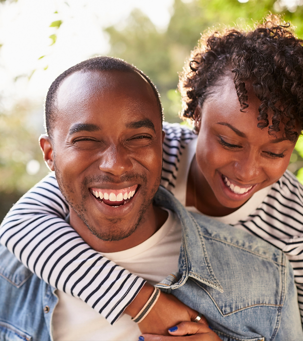 Smiling Black couple embracing outdoors for doctor marketing