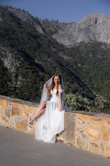 Bride in off-shoulder wedding dress smiling under her veil in Sequoia elopement session.