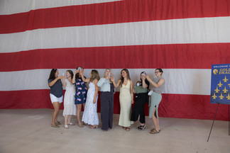 Navy spouses pose in front of giant American flag at NAS Lemoore