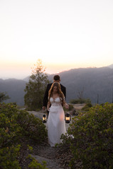 Couple holding lanterns during adventurous Sequoia wedding portraits at sunset.