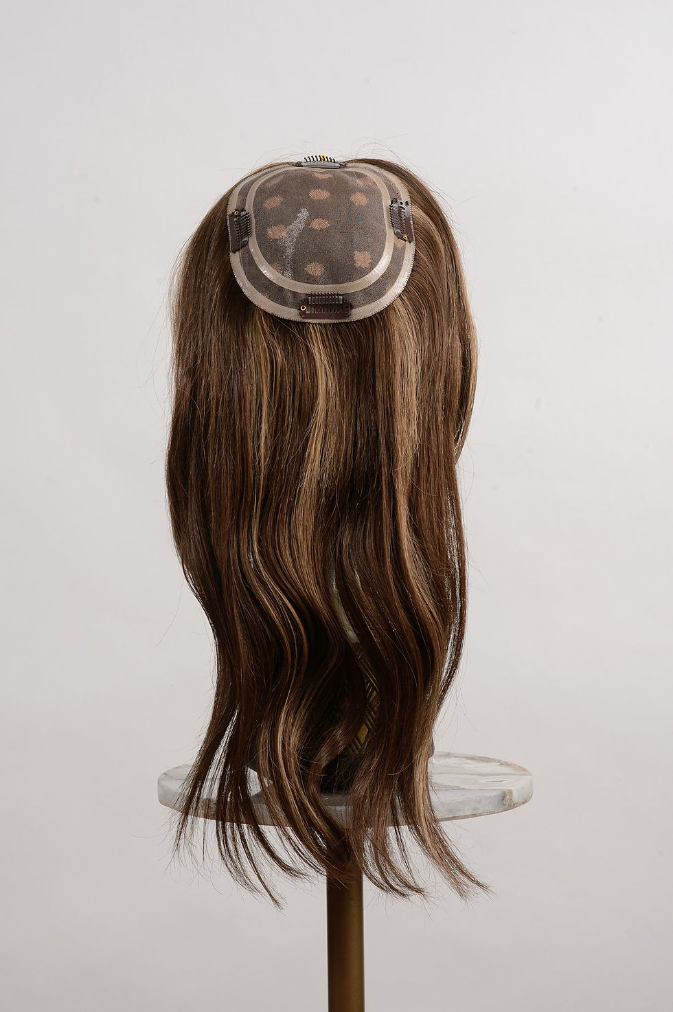 Thumbnail: underside of a 16 inches lenght Brown and caramel color human hair topper extension