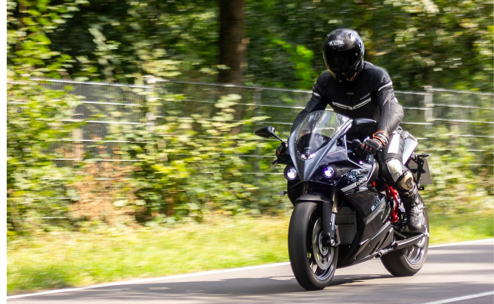 Motorcyclist on machine drives on country road
