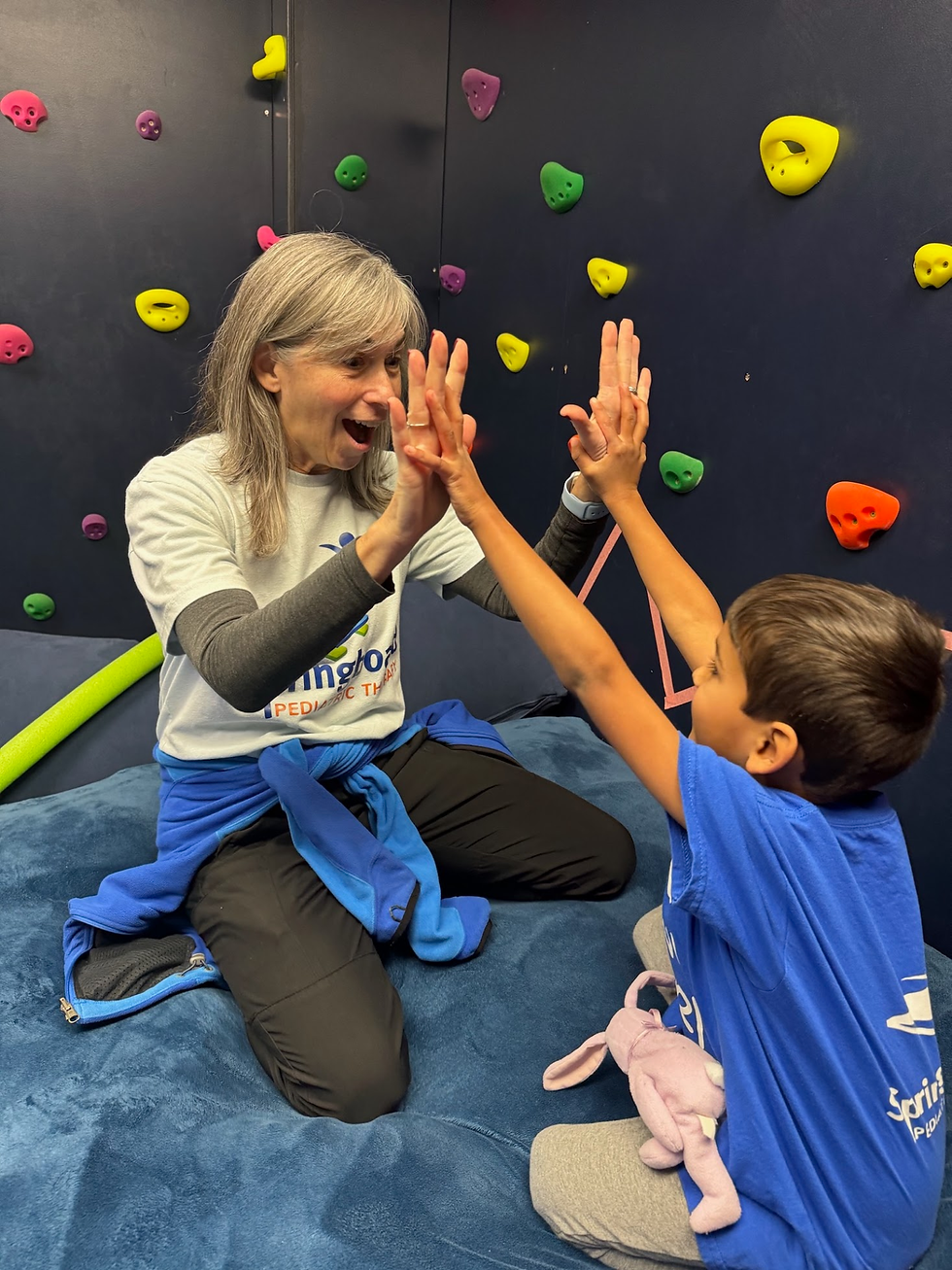 therapist and child high five