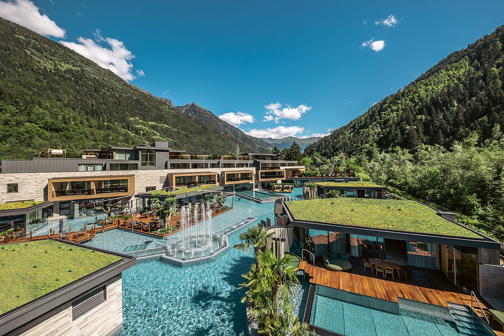 Aerial shot of Quellenhof See Lodge showing grass roofs and impressive water features