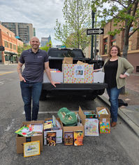 Employees posing with boxes of books collected by Treasure Valley D.L. Evans Bank employees for the United Way of Idaho.