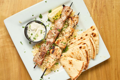 Pork shish kebobs served with pita and tzatziki – a best-rated Greek appetizer near Indianapolis