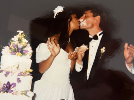 Dr. Tom Wagner and wife Dr. Lisa M. Moscoso sharing cake and kissing on their wedding day