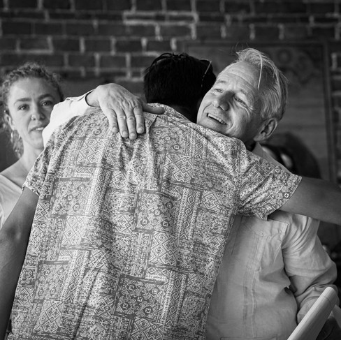 Resilience researcher and keynote speaker Dr. Tom Wagner hugging his son at the Sunday Morning Cafe event.