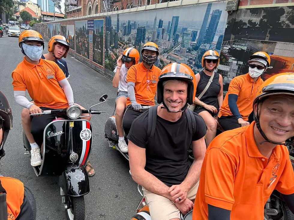 CNNGo crew capturing Saigon’s vibrant streets while riding a Vespa scooter.