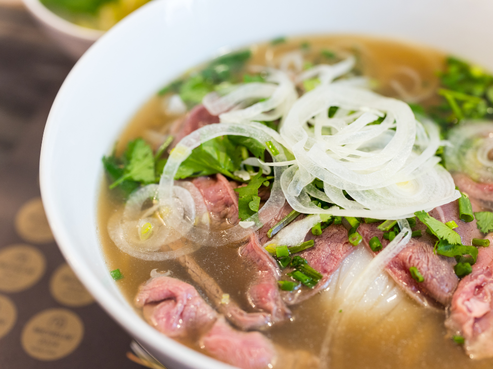 Hanoi food tour breakfast pho steaming bowls Dong Xuan Market vendors