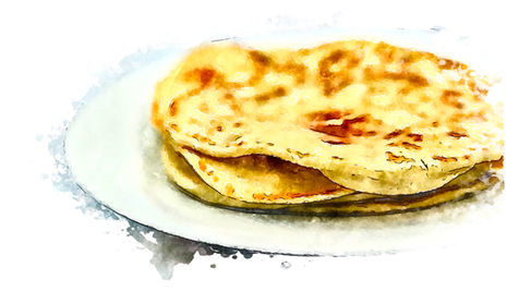 Stack of golden Italian flatbread Piadina with charred spots from griddle cooking on white ceramic plate