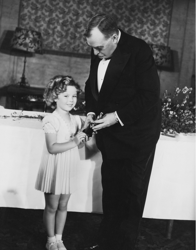 Shirley receiving her juvenile Oscar from humorist Irvin Cobb at the 7th Academy Awards ceremony (held February 27, 1935)
