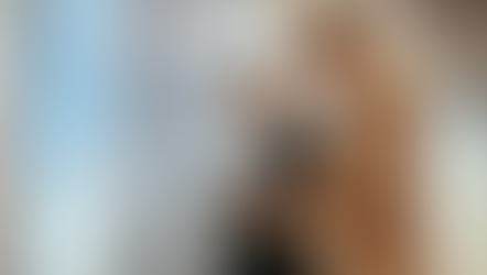 Two co-workers looking at a clipboard together