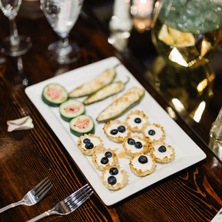 Top L: Pickled Radish Cucumber Cups, Bottom: Honey Goat Cheese Phyllo Cups (Shane Long Photography)