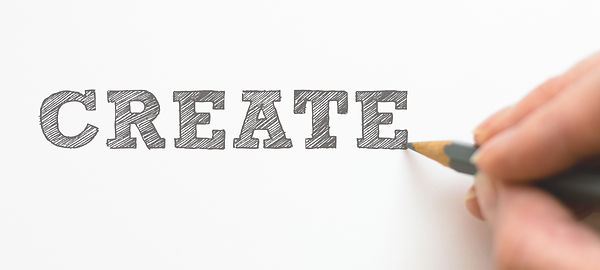 Artist drawing the word "create"