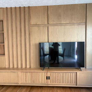 Wooden entertainment center with decorative panel and integrated storage