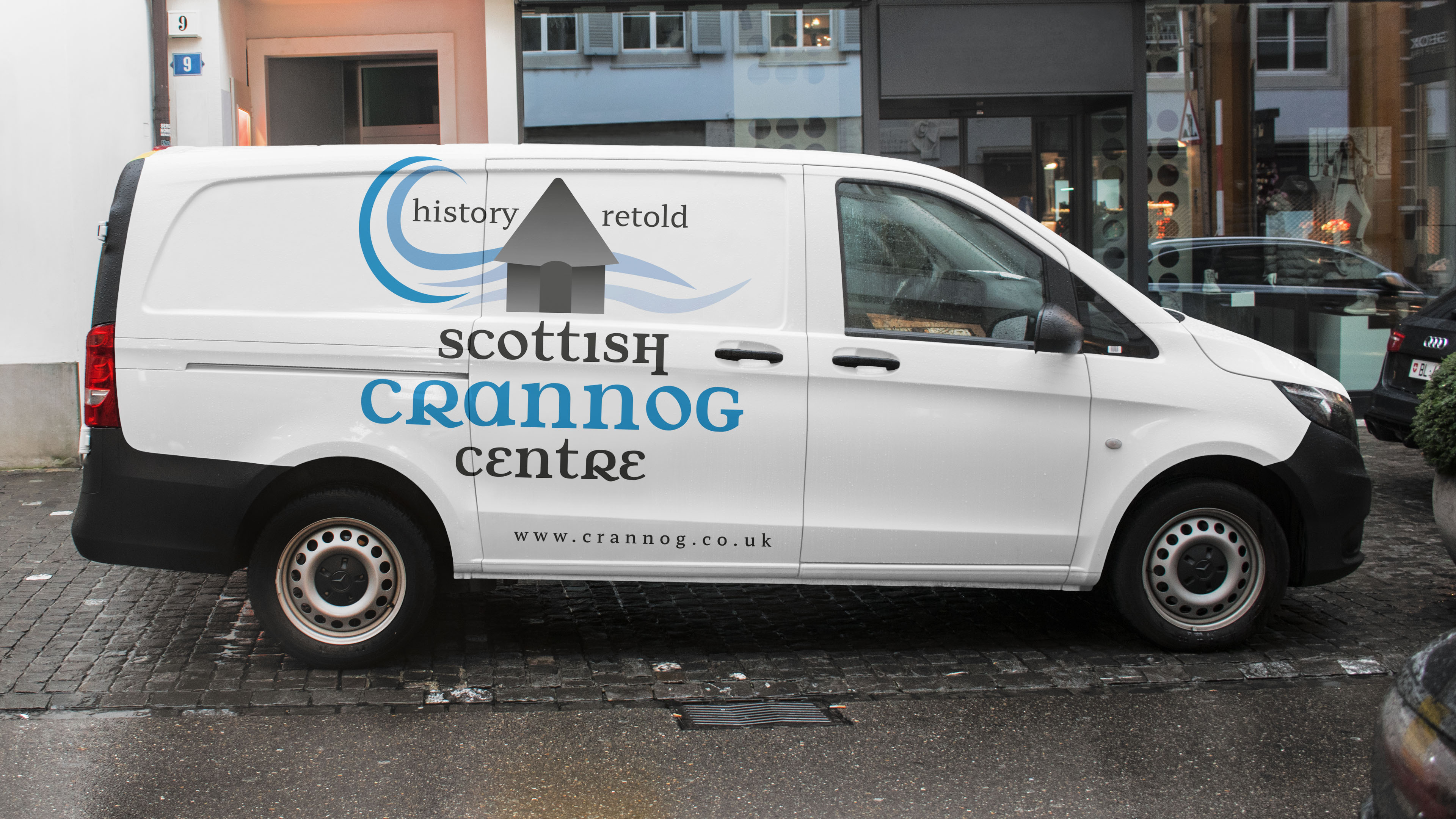 van parked in a street with the scottish crannog centre brand identity printed on the side of the vehicle 
