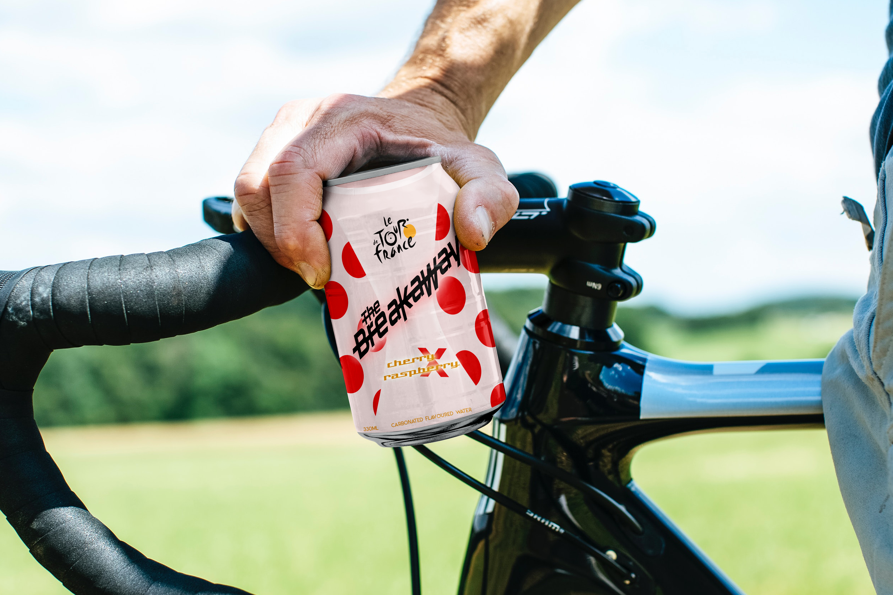 a light pink polka dot can of The Breakaway carbonated water held over the handle bars of a bike 