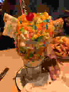 A Fruity Pebbles shake with a Pop Tart, Rice Krispy treat, Laffy Taffy candy, Whipped cream and cherry