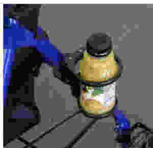 a cup holder on a walker with a bottle of orange juice