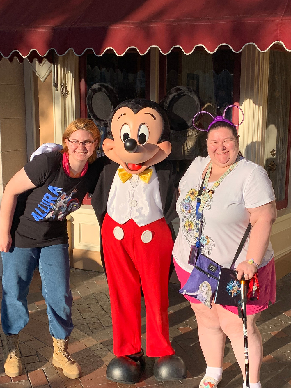 2 woman and Mickey Mouse