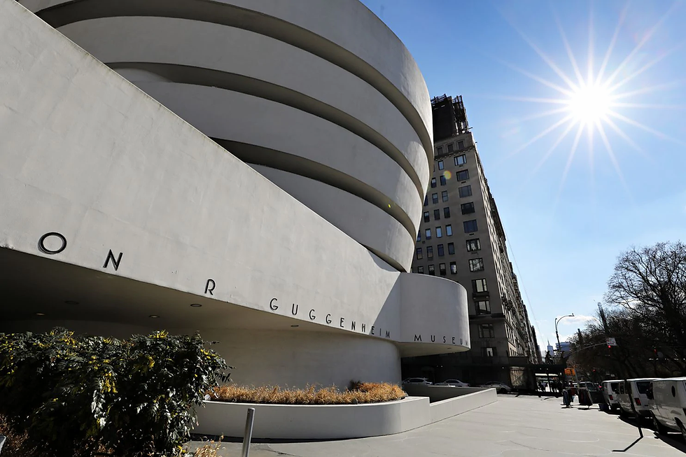 a photo of the outside of the museum its a white buiilding in a round shape