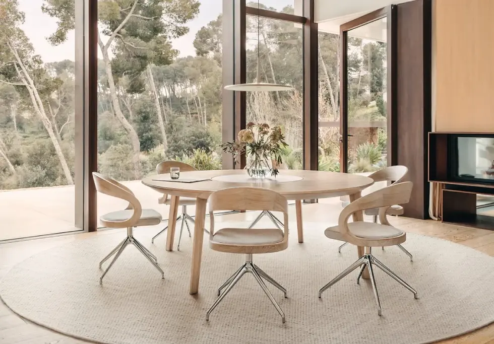 Round extendable solid wood dining table by TEAM 7 Miró designed for social dining