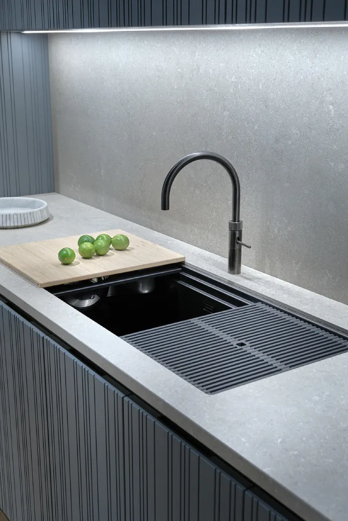 Honed stone countertop with integrated sink in a modern European kitchen showcasing a soft matte finish.
