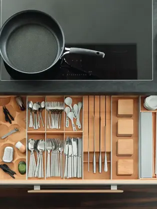 Luxury kitchen drawer organizer with wooden compartments for utensils and cookware storage