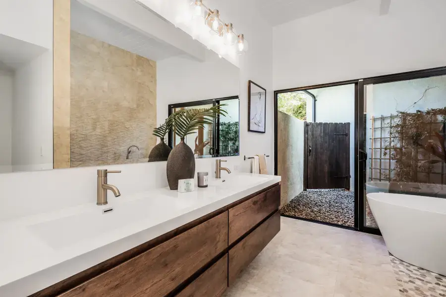 European style bathroom remodel featuring custom wood vanity, integrated sink, freestanding tub, and modern Italian-inspired design.