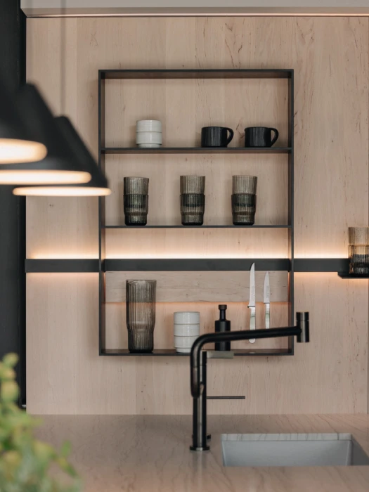 TEAM 7 Modern open shelving kitchen with integrated lighting, wood shelves, and European-inspired cabinetry