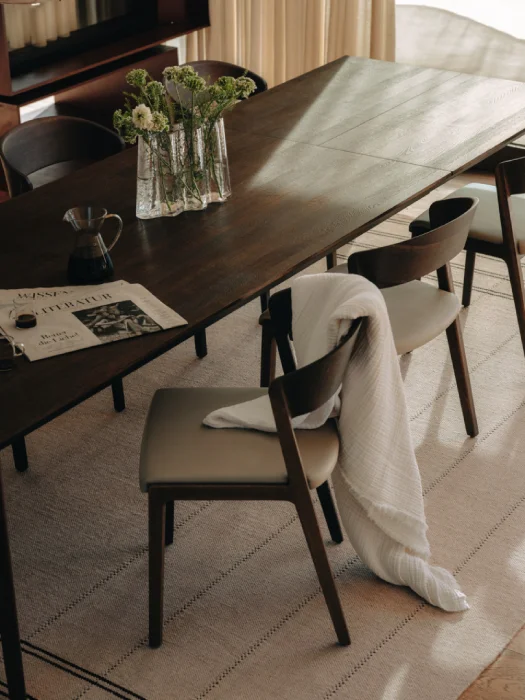 Solid wood dining chairs by TEAM 7 paired with extendable dining table