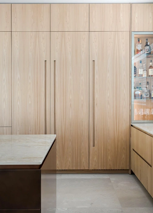 Minimalist European kitchen cabinets with hidden storage and seamless wood finishes