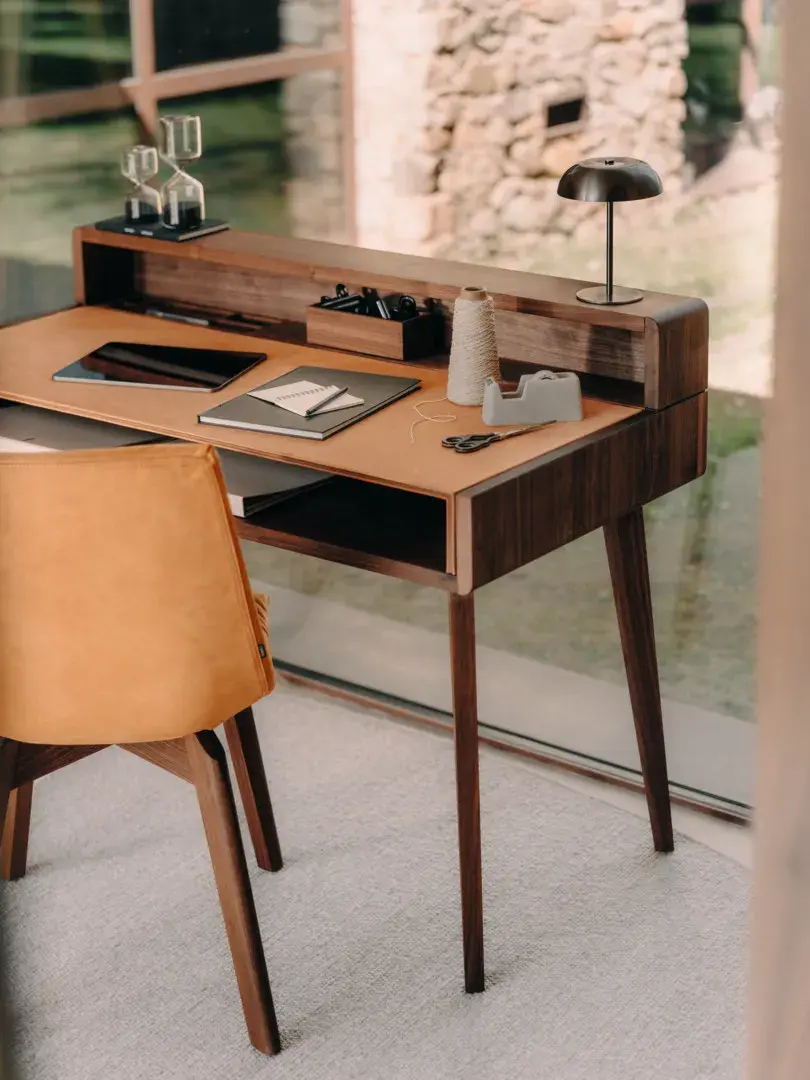The TEAM 7 Sol writing desk combines solid wood craftsmanship with leather detailing and smart integrated storage for a refined home office.