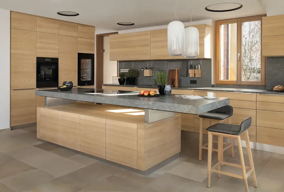 TEAM 7 K7 kitchen with oak white oil cabinetry, island and gray stone countertops
