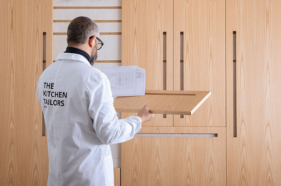 TM ITALIA cabinet makers inspecting D90 inset handle cabinet doors.
