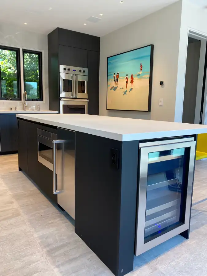 Custom European kitchen featuring continuous tile flooring installed before cabinetry for a clean architectural finish